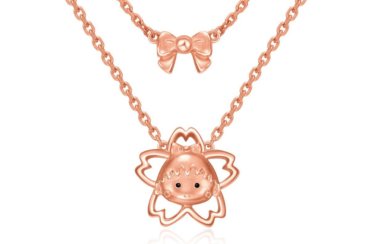 The rose gold double-layer necklace with adorable Japanese-style elements is both playful and sophisticated.