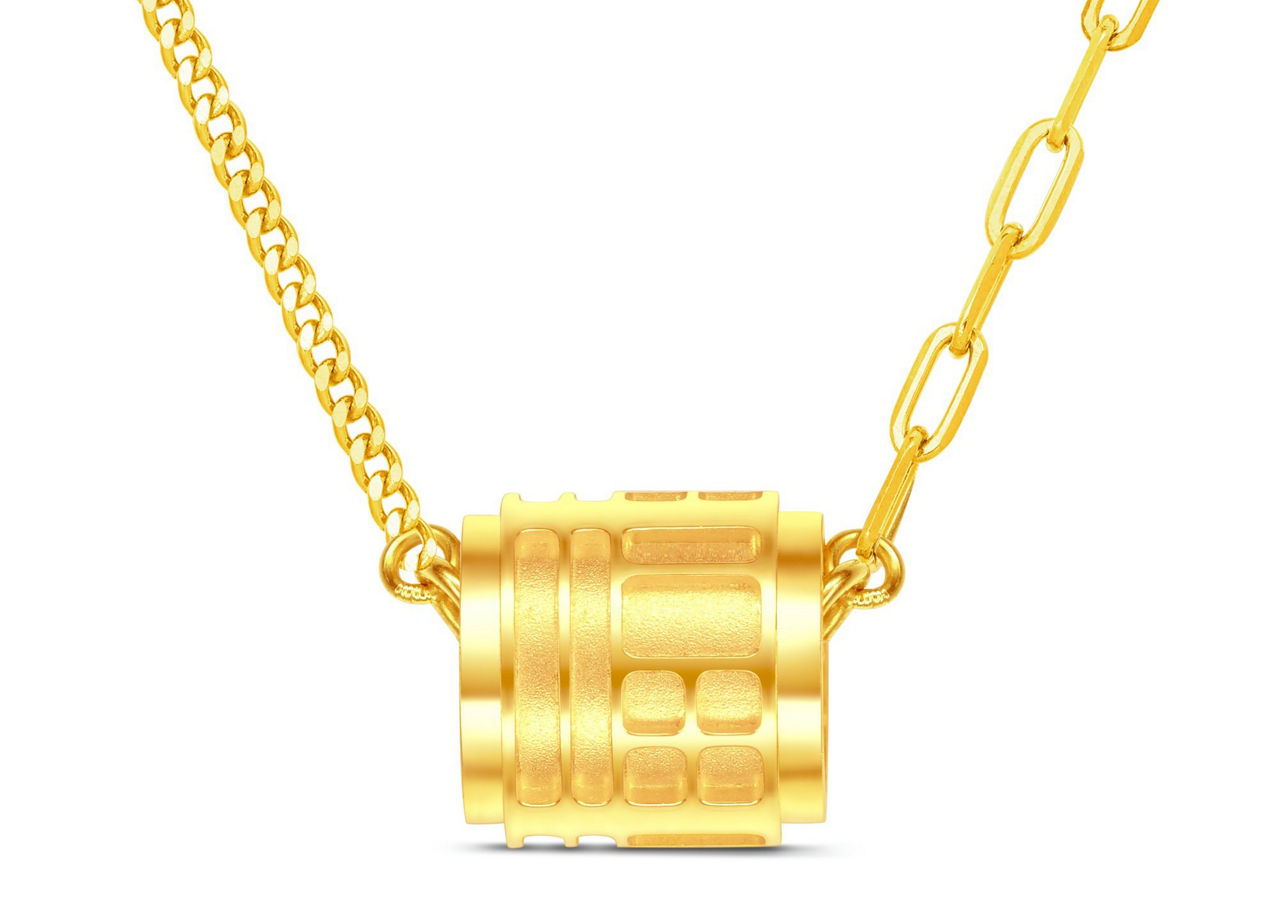 An exquisite cylindrical gold pendant necklace, blending traditional and modern designs.