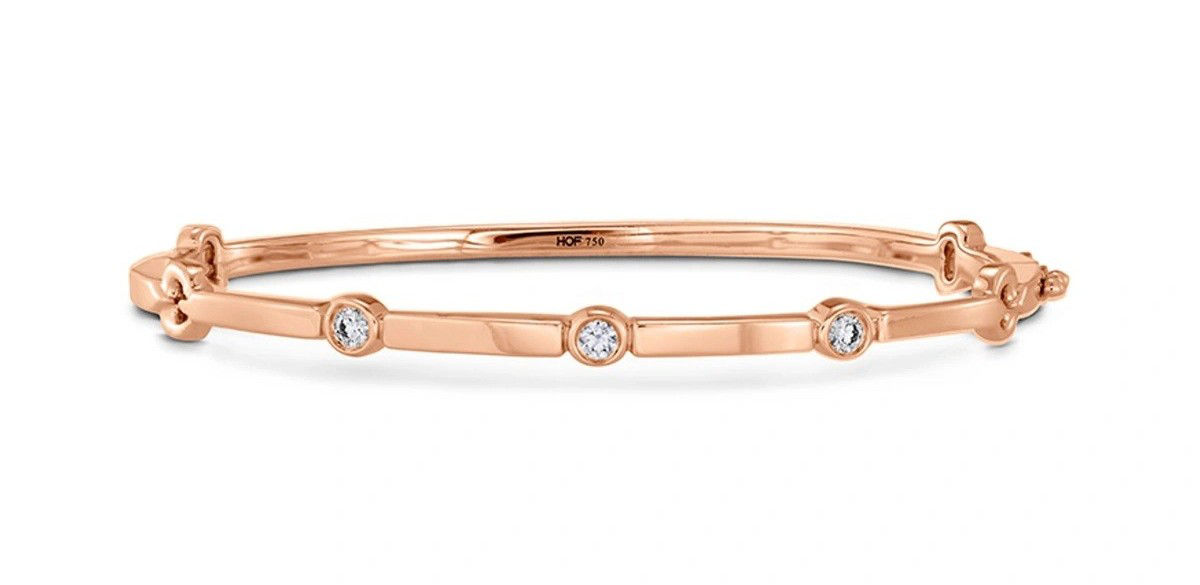 A minimalist rose gold bracelet with three diamonds, simple yet elegant.