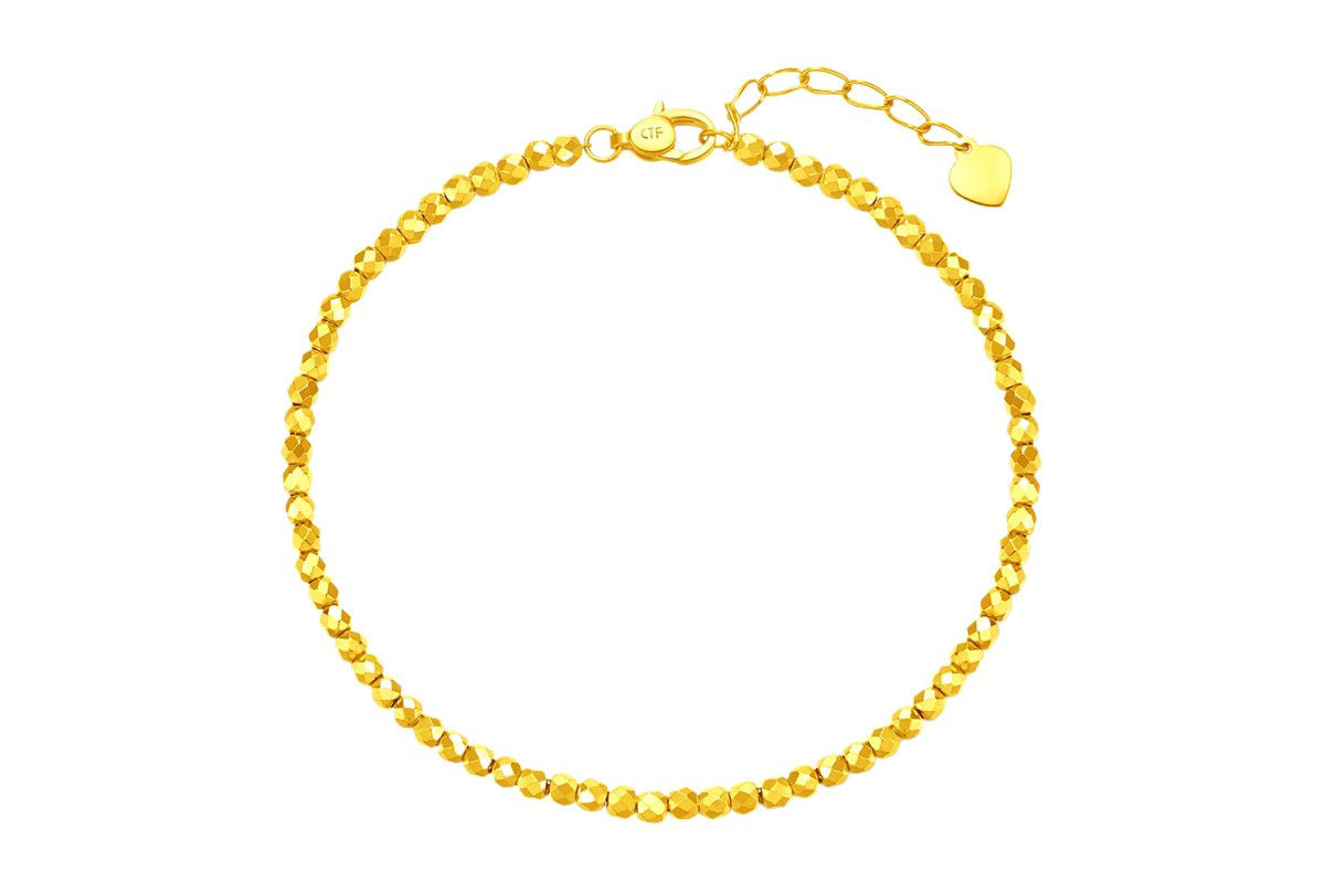 A simple and delicate solid gold bracelet with intricate bead design, perfect for everyday wear or layering.