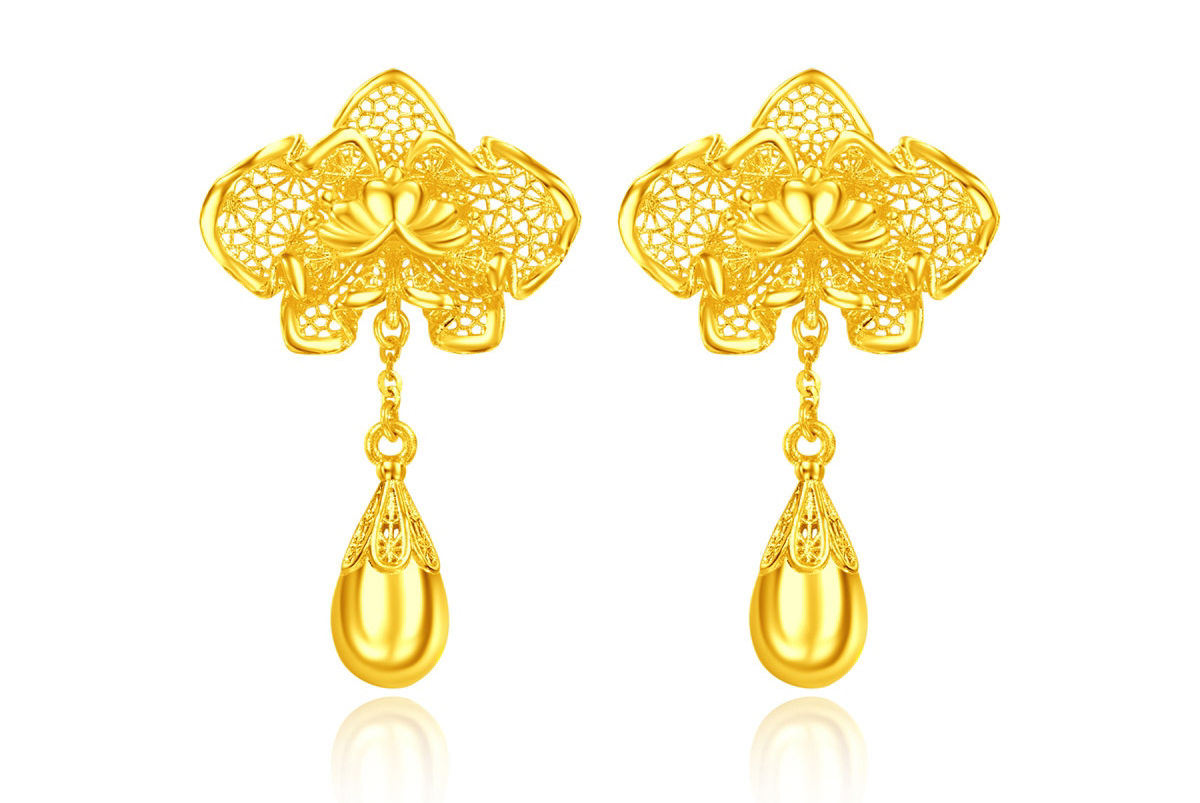 Sculptural orchid pure gold earrings, elegantly blooming with swaying teardrops, a timeless witness to pure love.