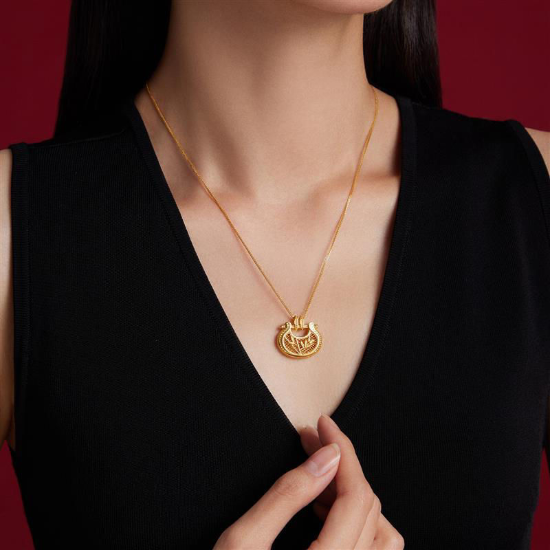 Gold pendant with Ruyi lock and bamboo design, symbolizing good luck and success.